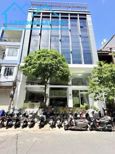 Bán Nhà 7 Tâng - Mặt tiền Hẻm 12m Nguyễn Gia Trí, 12x20m, Dòng tiền 300 triệu, 89,9 Tỷ.
